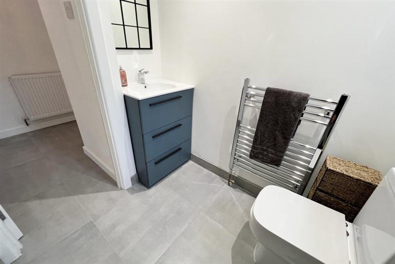 Tiled bathroom with towel radiator