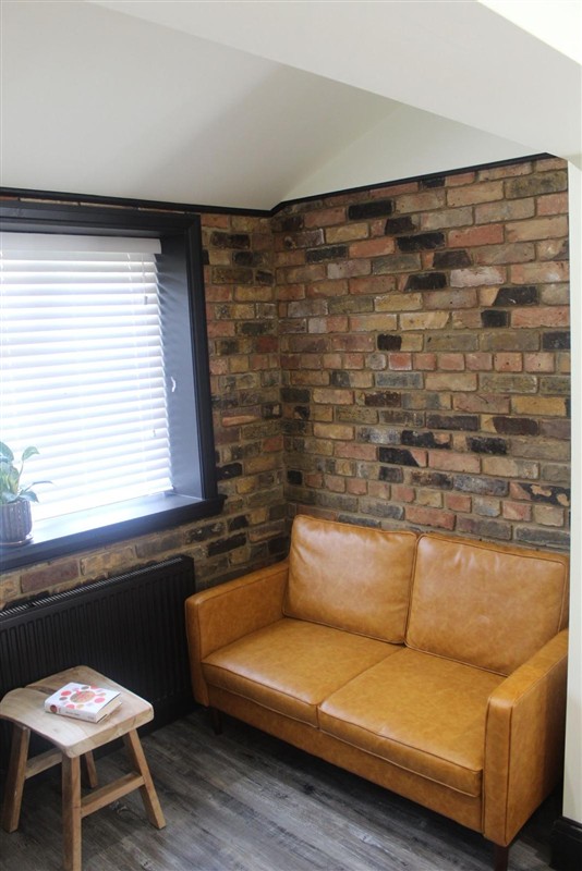 Seating area with exposed brick wall