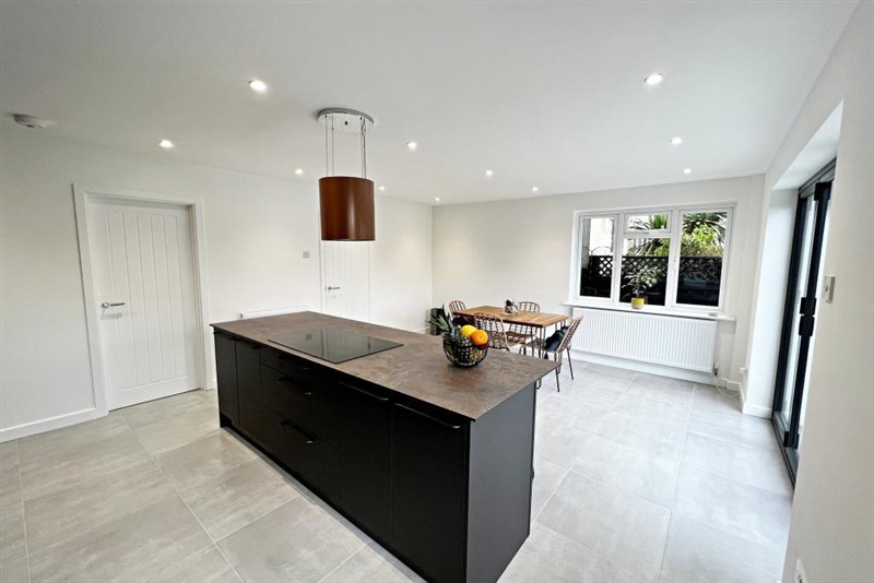 Kitchen island with dark cabinetry