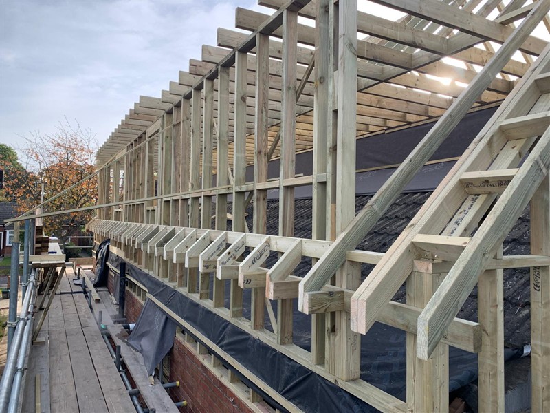 Timber structure beside scaffolding