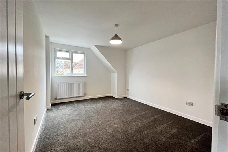 Carpeted room with dormer window
