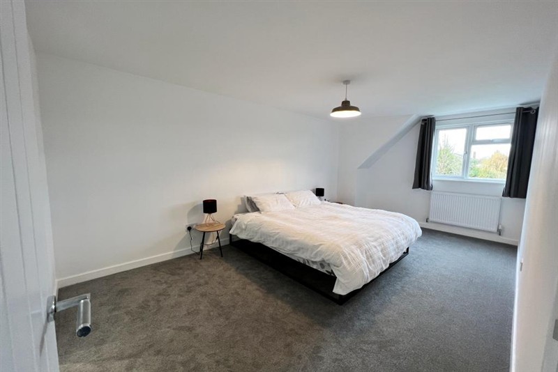Bedroom beneath a sloping ceiling